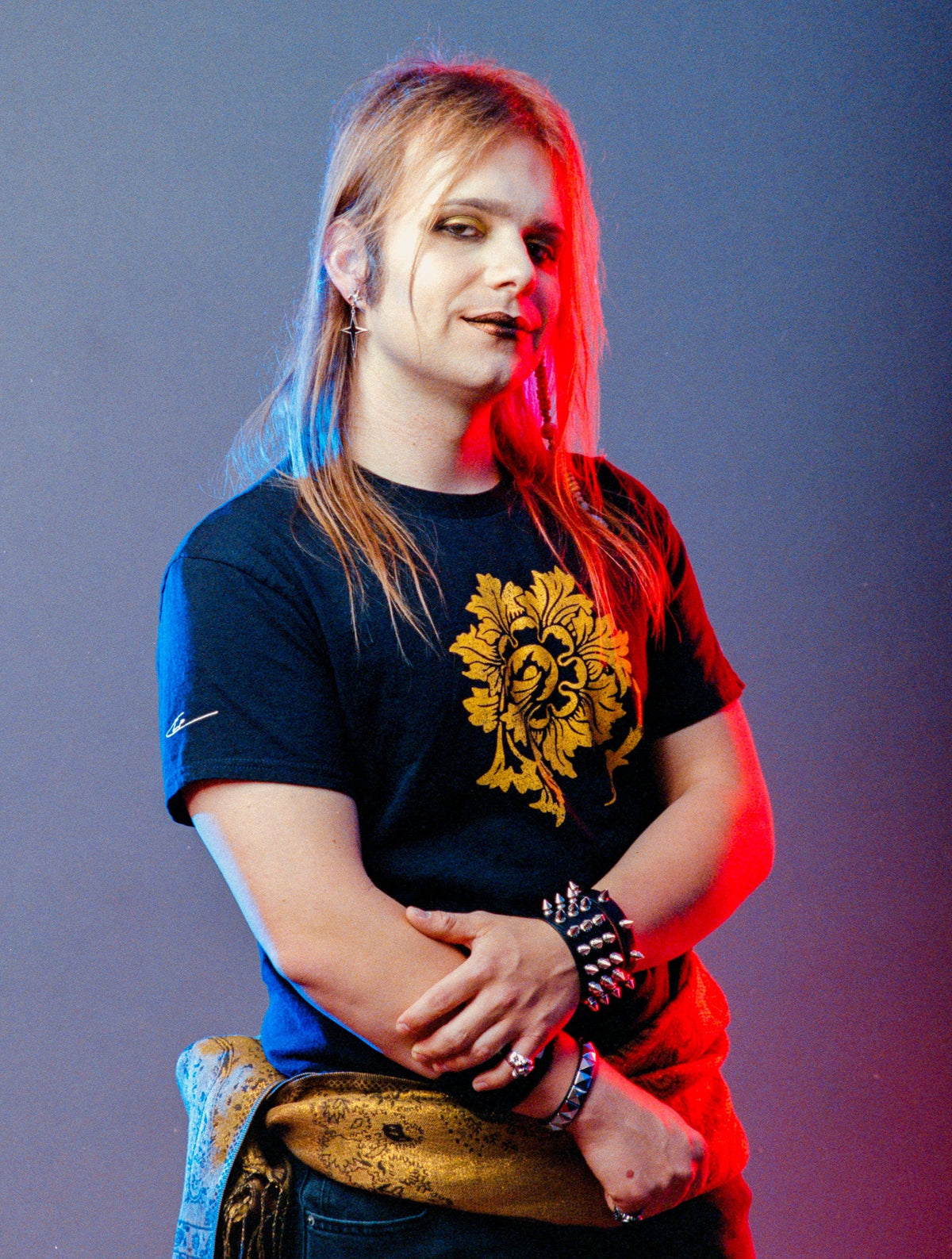 Person wearing a black t-shirt with a yellow graphic design on a gradient background