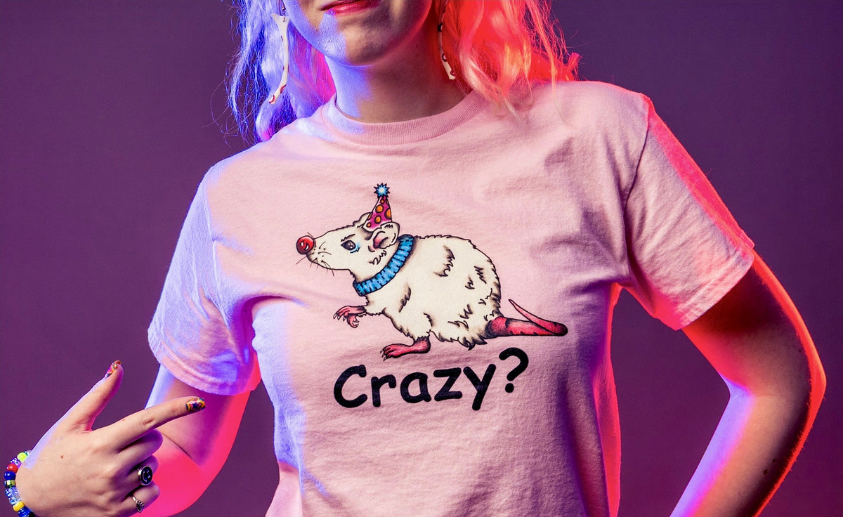 Person wearing a t-shirt with a rat graphic and 'Crazy?' text, against a purple background.